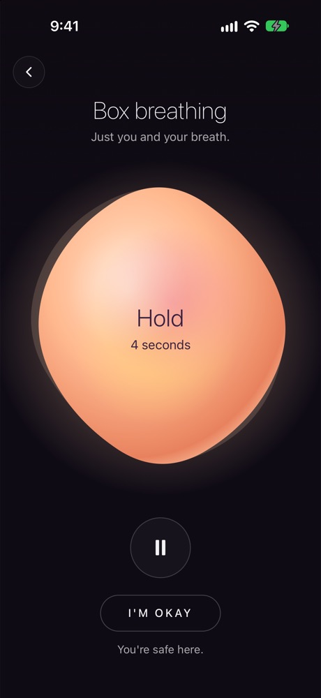 A box breathing session: a large glowing peach ball that says Hold.